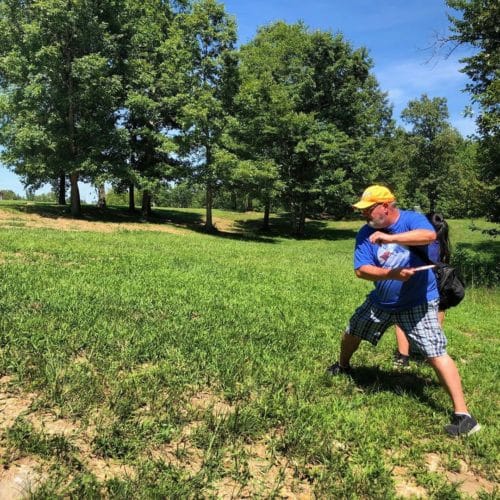 guest playing frisbee disc golf