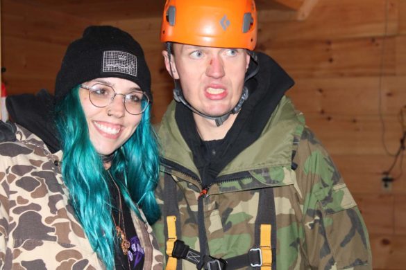 couple wearing zipline equipment