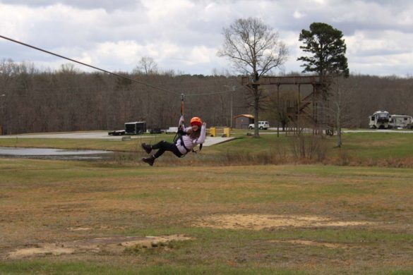 woman on zipline waving