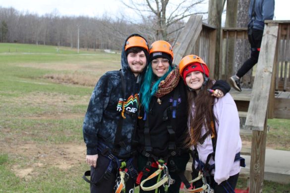 group of zipliners smiling before they zipline
