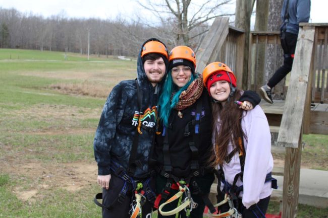 group of zipliners smiling before they zipline