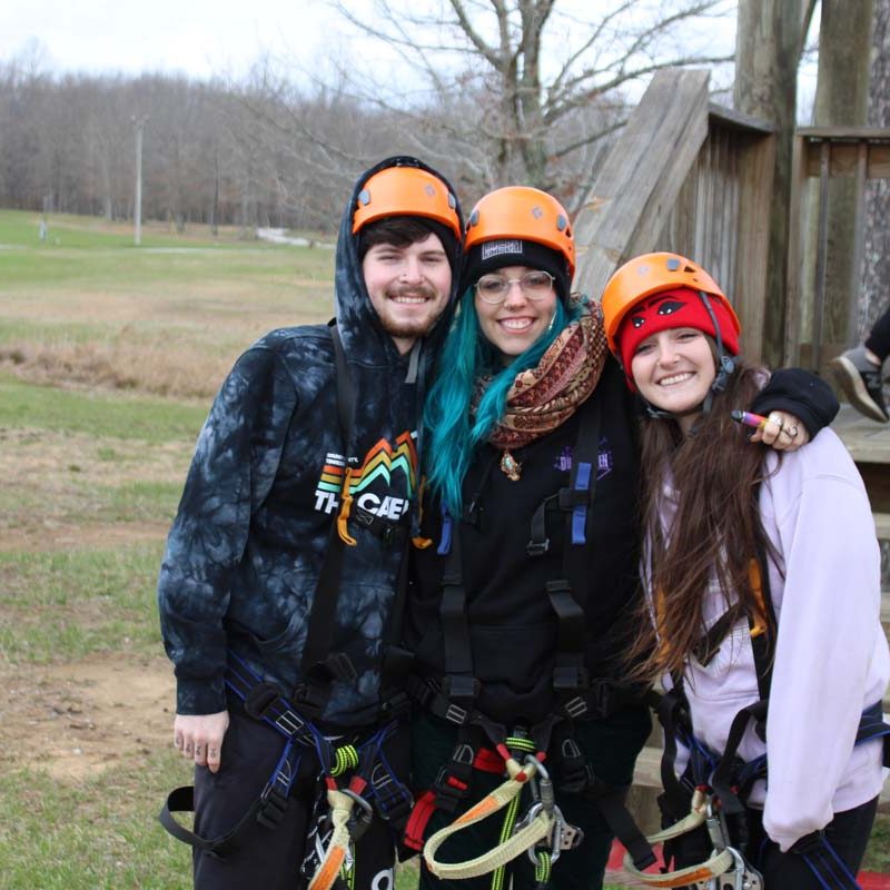 group of zipliners smiling before they zipline
