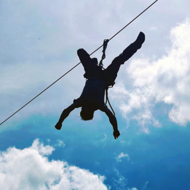 zipliner flying over a camera